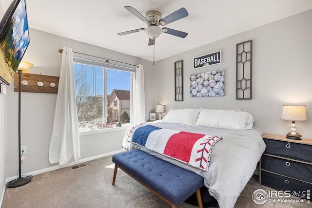 bedroom with baseboards, visible vents, carpet flooring, and ceiling fan