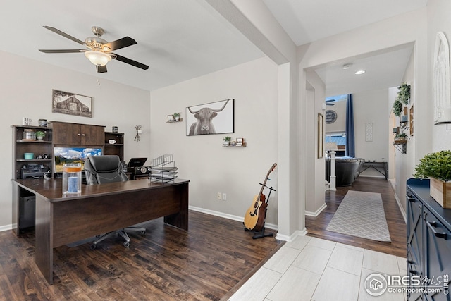 office space featuring ceiling fan, baseboards, and light wood finished floors