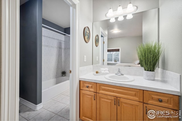 full bathroom featuring tile patterned floors, vanity, and  shower combination