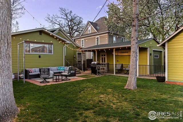 back of house featuring a patio, fence, an outdoor hangout area, and a yard