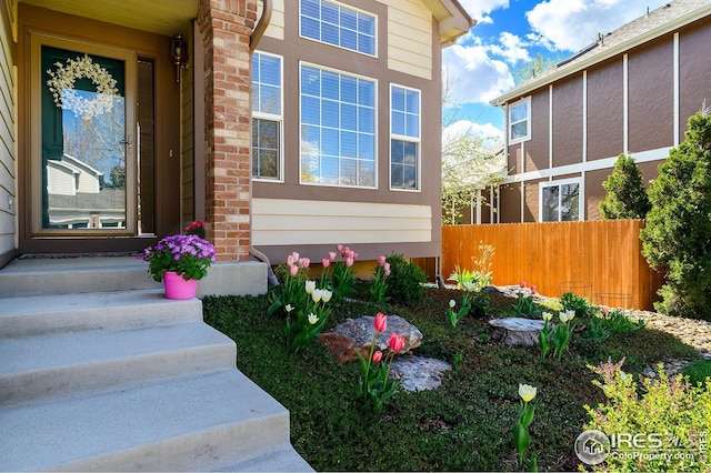 view of exterior entry with fence