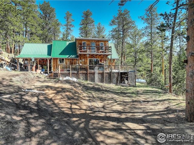 147 Cedar Dr, Lyons, CO 80540 - view of front of home featuring metal roof, a wooden deck, and a balcony