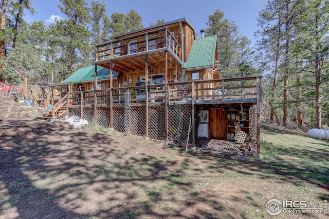 147 Cedar Dr, Lyons, CO 80540 - back of property featuring a deck, metal roof, and stairs