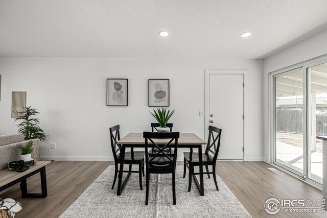dining space featuring recessed lighting, wood finished floors, and baseboards
