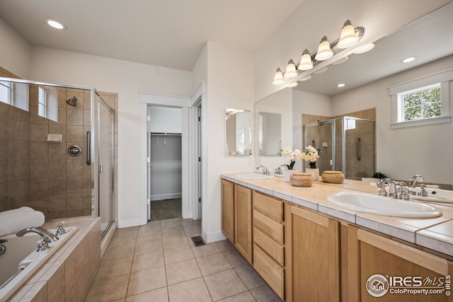 3122 Notabon Ct, Lafayette, CO 80026 - bathroom with a stall shower, double vanity, tile patterned flooring, a garden tub, and a spacious closet