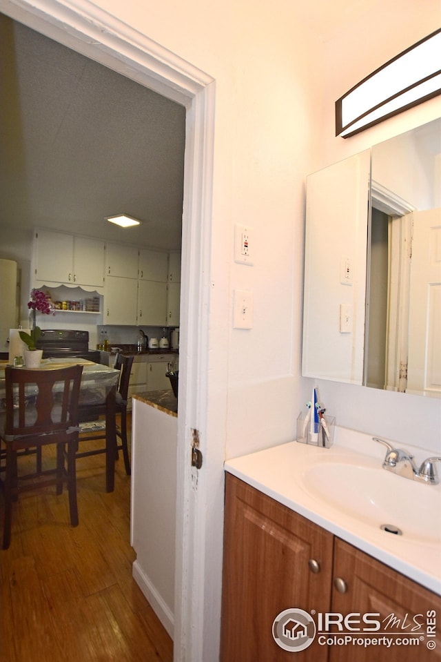 1021 5th St, Greeley, CO 80631 - bathroom featuring wood finished floors and vanity