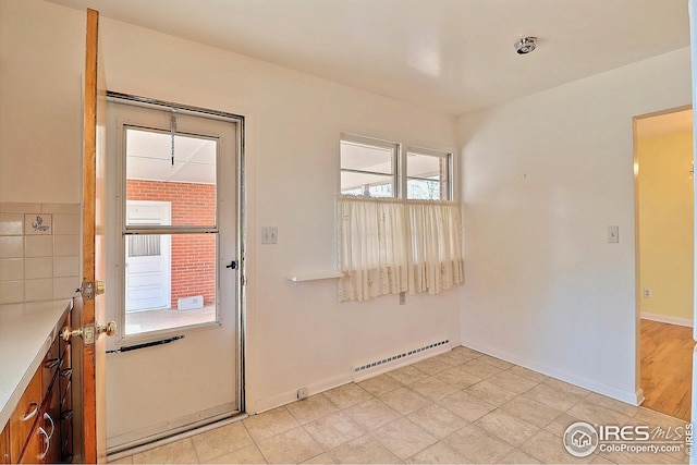 doorway featuring baseboards and baseboard heating