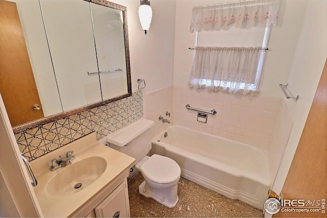 full bath featuring a washtub, wainscoting, tile walls, toilet, and vanity