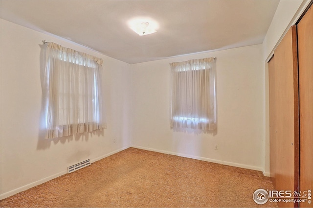 unfurnished bedroom with visible vents, baseboards, and carpet floors