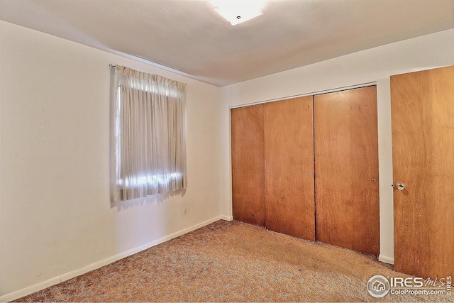 unfurnished bedroom with carpet and baseboards