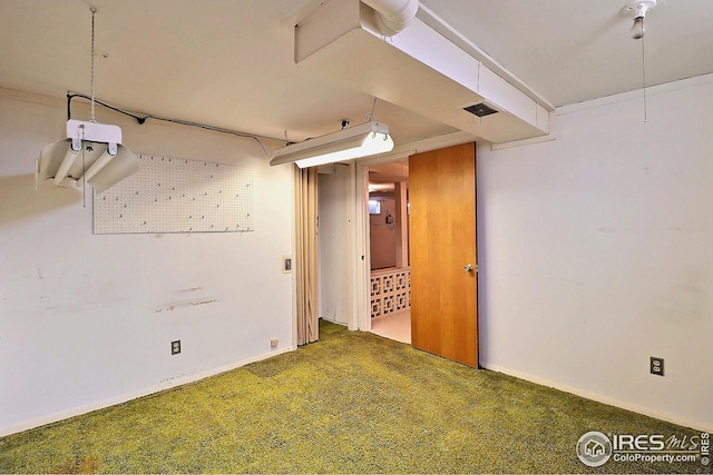 below grade area featuring carpet flooring and baseboards