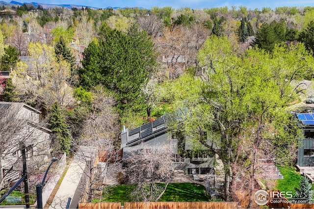 birds eye view of property featuring a wooded view