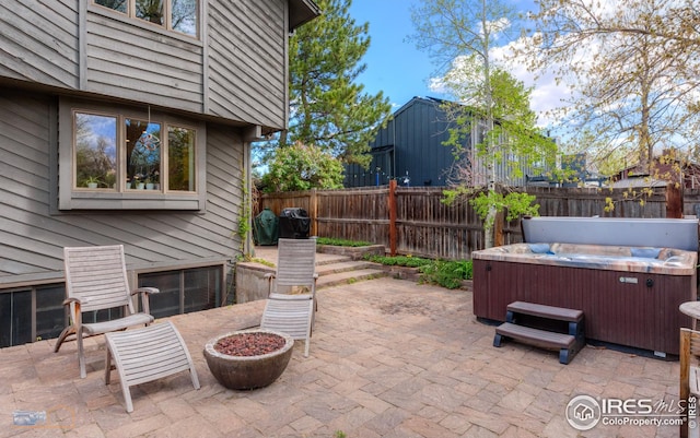 view of patio / terrace featuring a fenced backyard and a hot tub