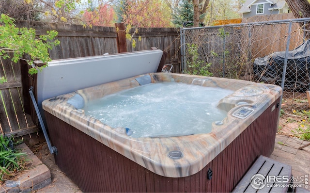 wooden deck featuring a hot tub and fence