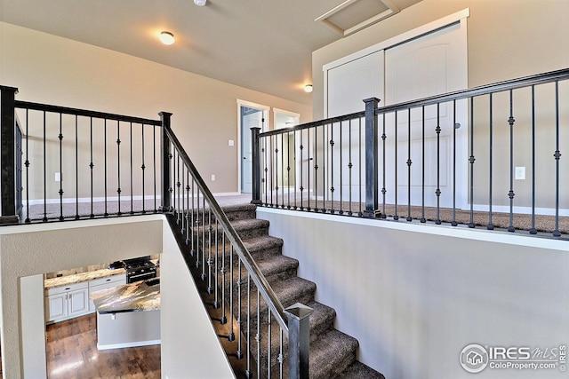 staircase featuring wood finished floors