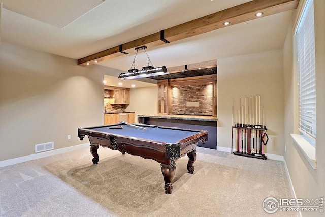 rec room with beamed ceiling, visible vents, light colored carpet, and baseboards