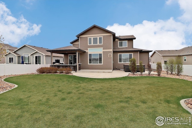 back of house with a yard, a fenced backyard, and a patio area