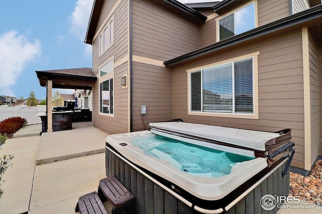 exterior space with a hot tub