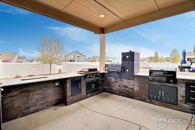 view of patio featuring a residential view, area for grilling, and fence