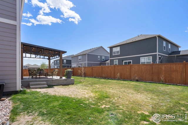 view of yard with a patio, a residential view, and a fenced backyard