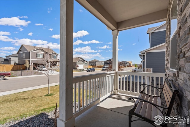 balcony with covered porch and a residential view