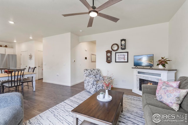 living room with dark wood-style floors, recessed lighting, a fireplace, ceiling fan, and baseboards