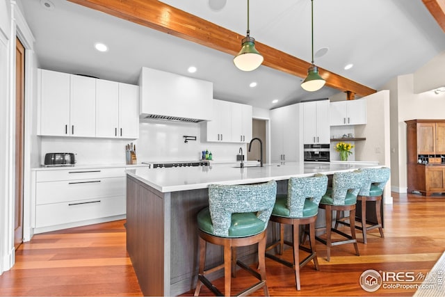 1533 Old Tale Rd, Boulder, CO 80303 - kitchen with backsplash, light countertops, light wood finished floors, hanging light fixtures, and recessed lighting