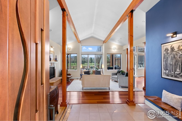 1533 Old Tale Rd, Boulder, CO 80303 - foyer entrance with a glass covered fireplace, light tile patterned floors, and high vaulted ceiling