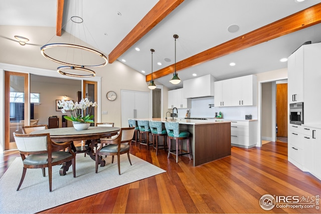 1533 Old Tale Rd, Boulder, CO 80303 - dining space with beamed ceiling, dark wood-style floors, high vaulted ceiling, recessed lighting, and a chandelier