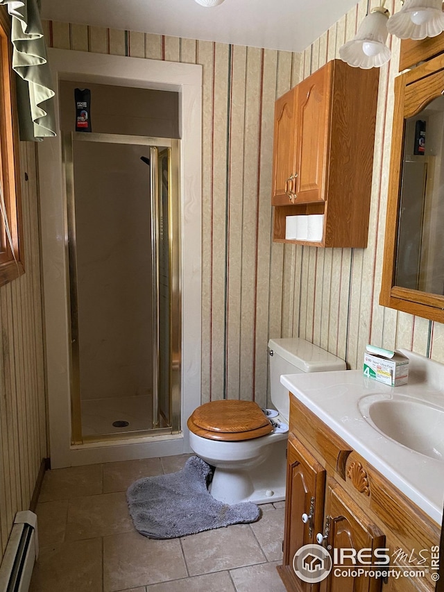 full bathroom with toilet, vanity, a shower stall, and baseboard heating