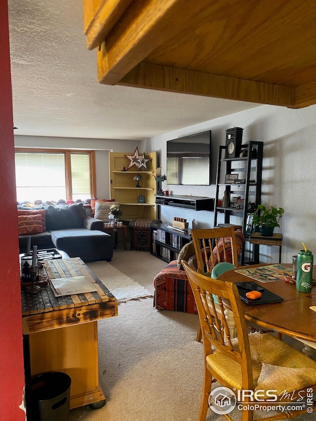 carpeted living room featuring a textured ceiling