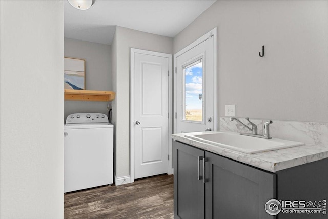 washroom featuring laundry area, washer / clothes dryer, dark wood-style floors, and a sink