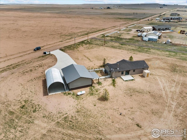 birds eye view of property with a rural view