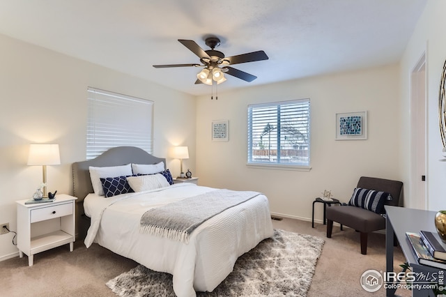 carpeted bedroom with baseboards and a ceiling fan