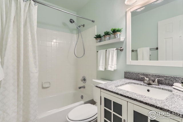 bathroom with shower / tub combo, vanity, and toilet