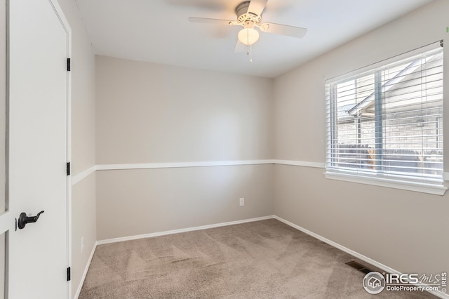 unfurnished room with a ceiling fan, carpet, and baseboards