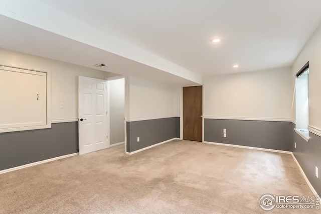 carpeted spare room featuring recessed lighting, visible vents, and baseboards