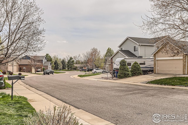 view of road featuring curbs, sidewalks, and a residential view