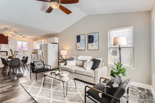 living room with a ceiling fan, wood finished floors, and lofted ceiling