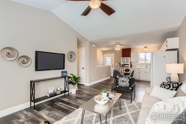 living room with baseboards, wood finished floors, a ceiling fan, and lofted ceiling