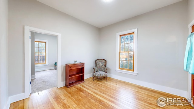 living area with light wood finished floors and baseboards