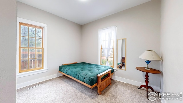 bedroom featuring visible vents, carpet flooring, and baseboards