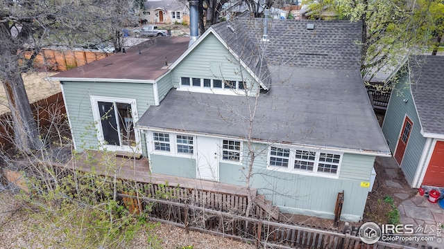 rear view of property with fence