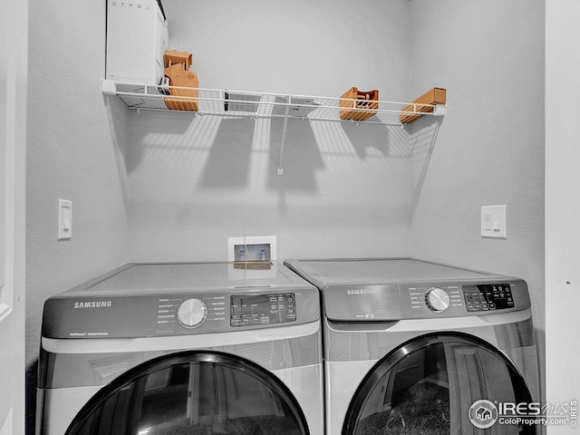 laundry room featuring washer and dryer and laundry area
