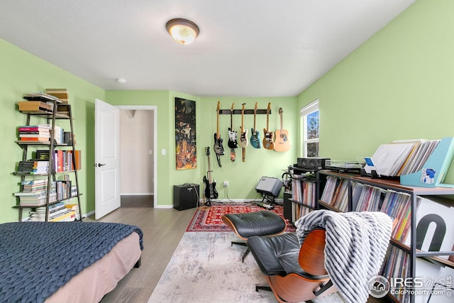 bedroom featuring wood finished floors and baseboards