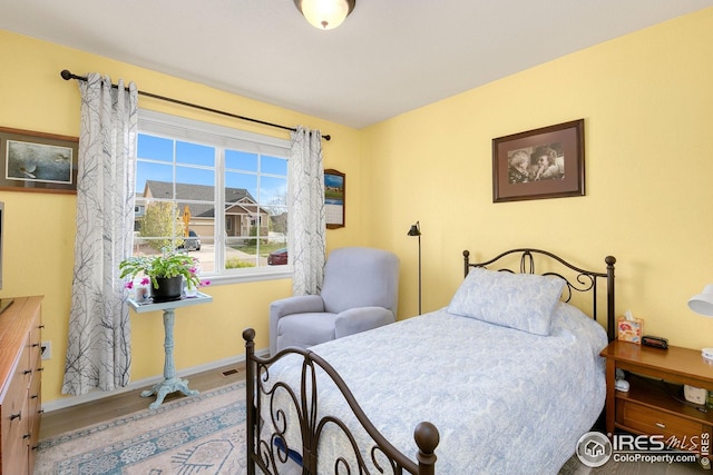 bedroom featuring visible vents and baseboards