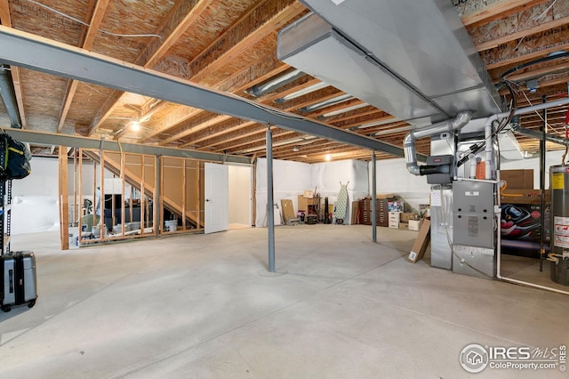 unfinished basement featuring gas water heater