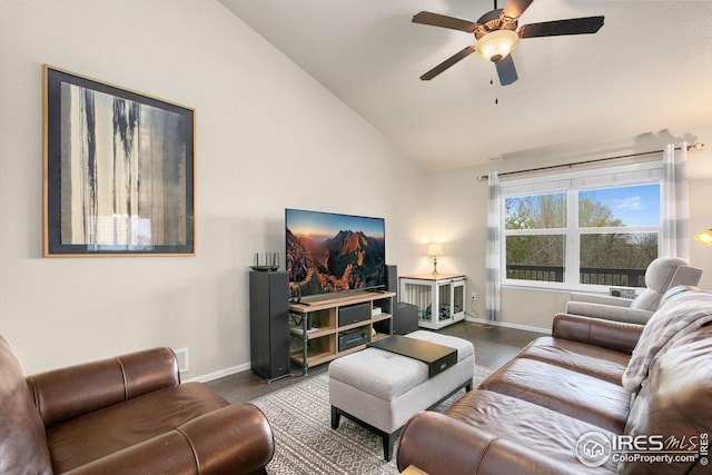living room with lofted ceiling, a ceiling fan, dark wood-style floors, and baseboards