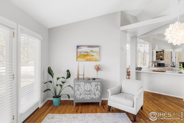 1891 Orchard Ave, Boulder, CO 80304 - sitting room with vaulted ceiling, wood finished floors, and baseboards