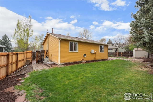 rear view of property with a fenced backyard, cooling unit, and a yard